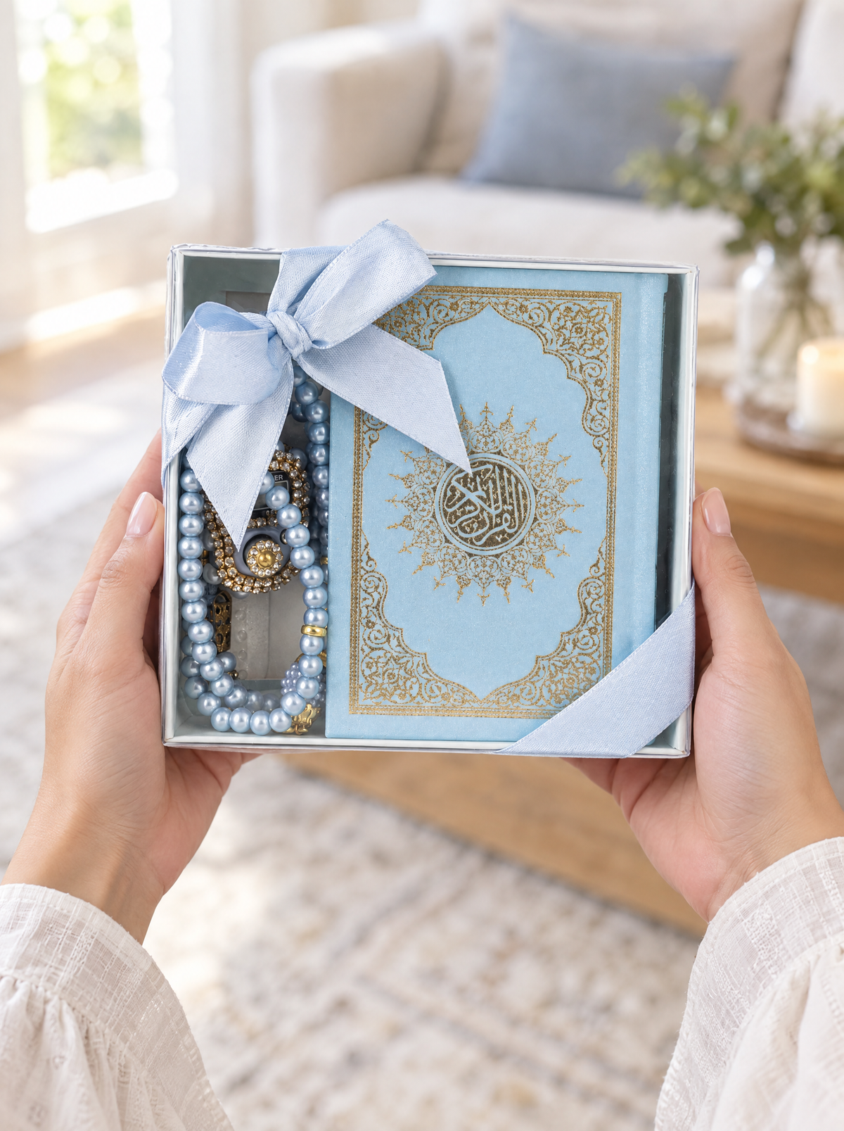 Hands giving the blue compact Quran set as a gift