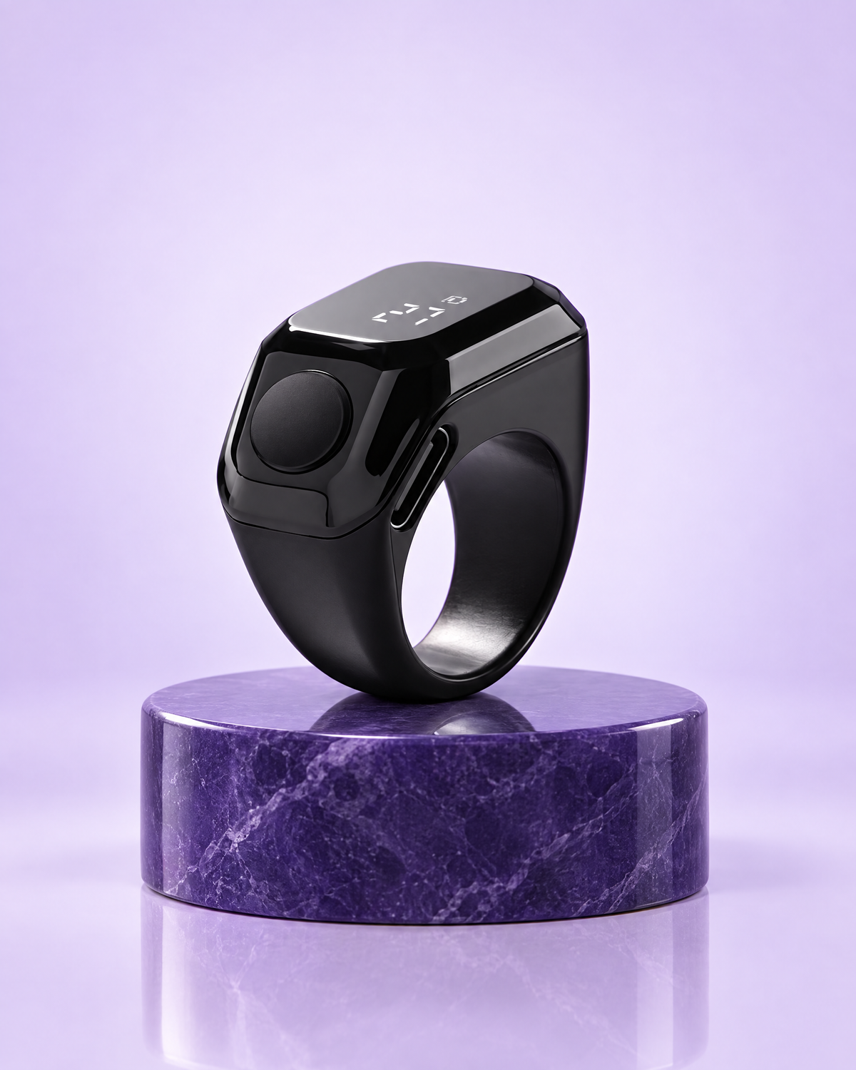 Black smart zikr counter ring on a purple pedestal