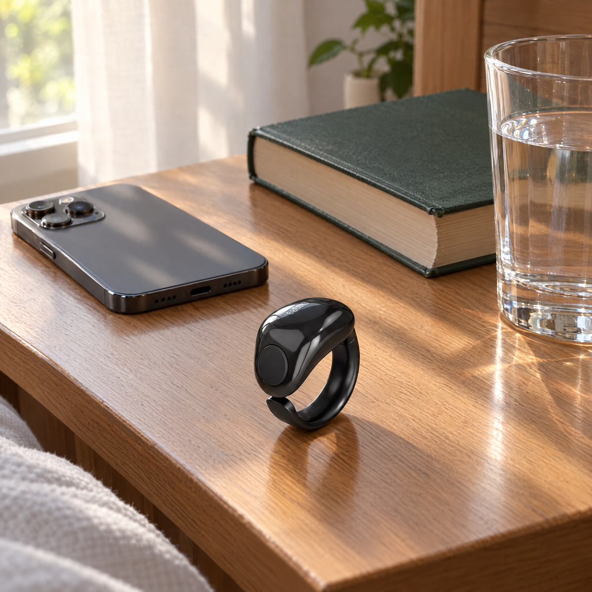 iTasbih smart ring on a bedside table with a Quran